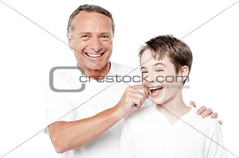 Playful father and son, pinching cheeks