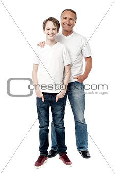 Smiling father and son posting together