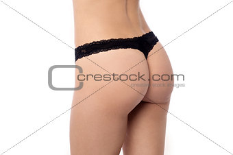 Sexy ass in black thong isolated on white
