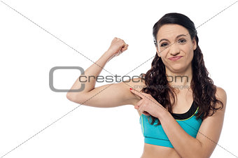 Sporty woman showing  her biceps