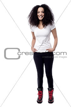 Smiling woman with hands in pockets