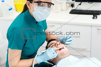 Dentist examining mouth of patient