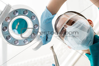 Dentist preparing dental lamp for working