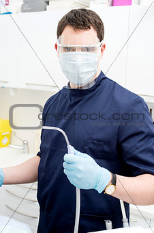 Dentist Holding Dental Tools