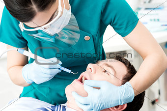 Professional dentist doing teeth checkup