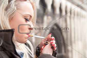 tourist lighting up a a cigarette in an European city