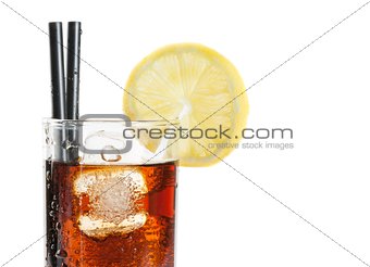 glass of fresh coke with straw with lemon slice on top, summer time