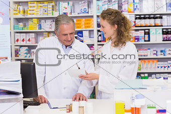 Team of pharmacists looking at prescription