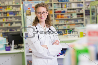 Pharmacist in lab coat with stethoscope and arms crossed