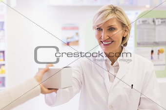 Pharmacist taking medicine to costumer