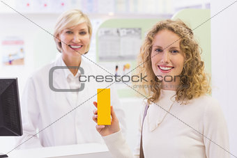 Smiling costumer with a medicine bottle