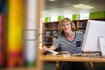 Student studying in the library with computer