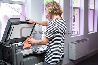 Student photocopying his book in the library