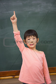 Cute pupil raising her hand