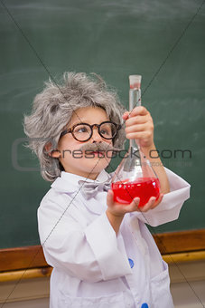Dressed up pupil looking at red liquid