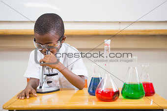 Pupil looking through microscope