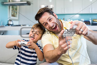 Father and son playing video games together