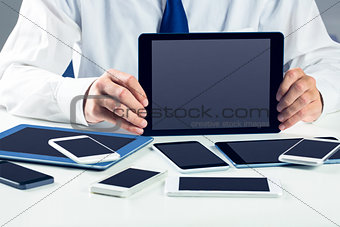 Businessman with smartphones and tablet
