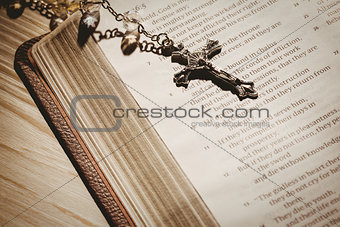 Open bible and silver crucifix