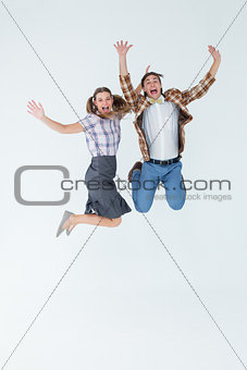 Geeky hipsters jumping and smiling