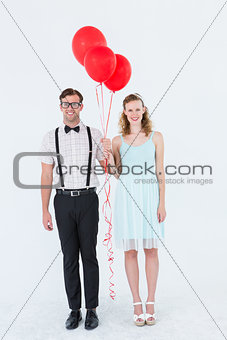 Geeky hipster couple hands in hands looking at camera