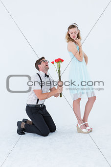 Geeky hipster begging his girlfriend taking roses