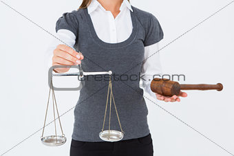Woman holding a gavel and scales of justice