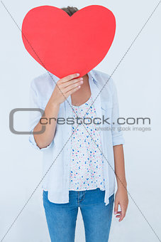 Woman holding heart card