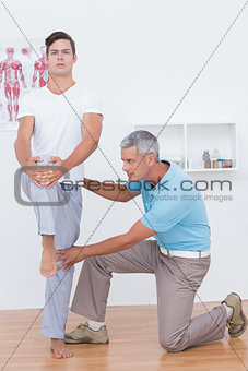 Doctor examining his patient legs