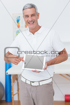Smiling doctor showing laptop pc