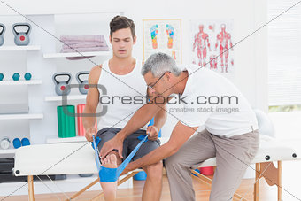 Doctor examining his patient back legs