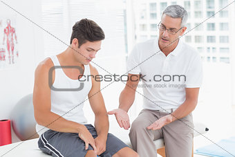 Doctor explaining something to his patient