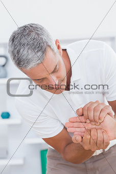 Doctor examining a male patients hand