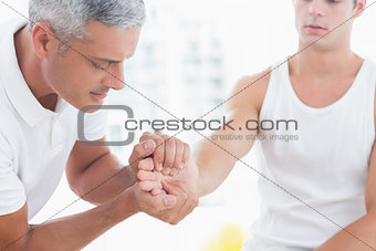 Doctor examining his patient hand