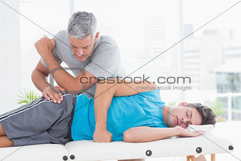 Doctor examining his patient pelvis