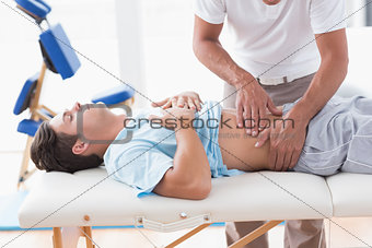 Doctor examining his patient stomach