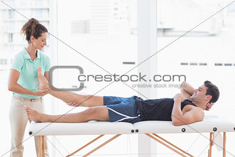 Doctor examining man leg