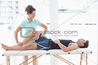 Doctor examining man leg