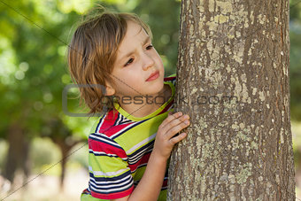 Little boy spying in the park