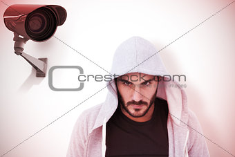 Composite image of portrait of dangerous man wearing hooded jacket
