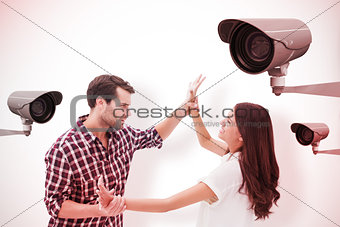 Composite image of fearful brunette being overpowered by boyfriend