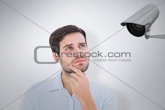 Composite image of serious thinking man looking up