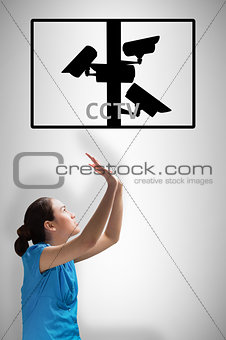 Composite image of young businesswoman pushing up