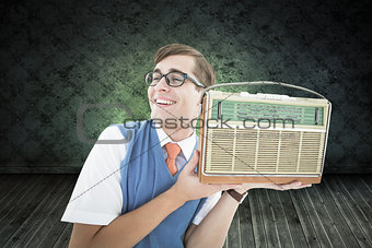Composite image of geeky hipster listening to retro radio