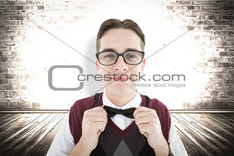 Composite image of smiling geeky hipster looking at camera