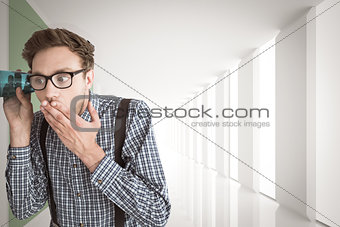 Composite image of geeky businessman eavesdropping with cup