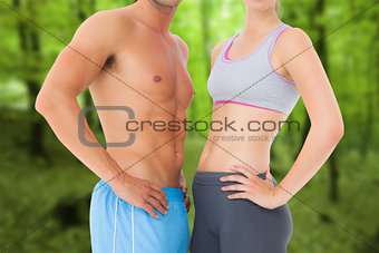 Composite image of mid section of a fit young couple