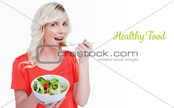 Healthy food against vegetable salad eaten by a smiling fairhaired woman