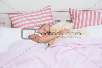 Cute little girl lying in bed