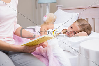 Mother reading daughter a bedtime story